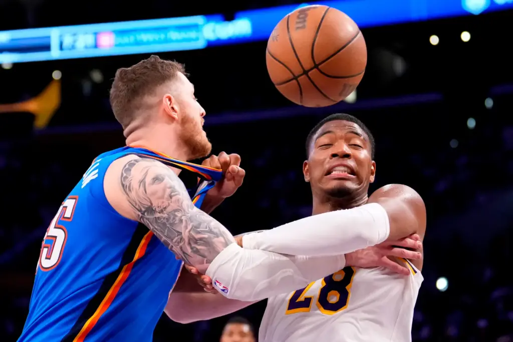 Oklahoma City Thunder center Isaiah Hartenstein, left, and Lakers forward...