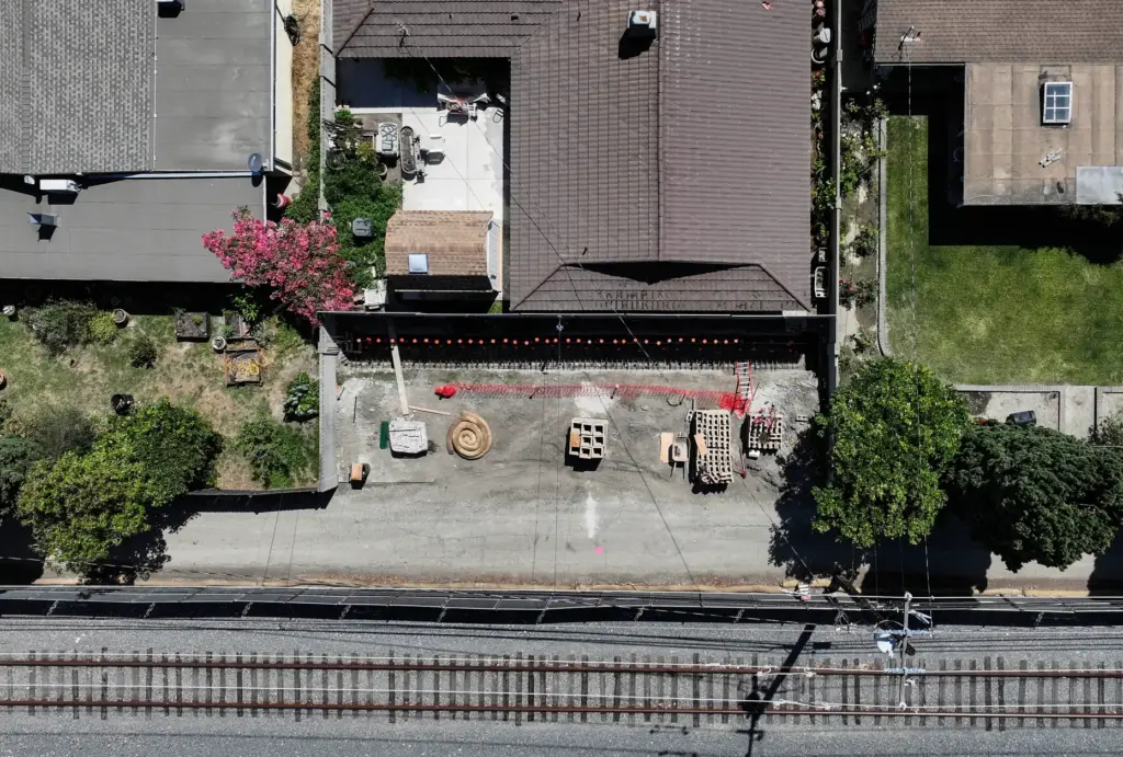 A new wall is being built in the backyard of...