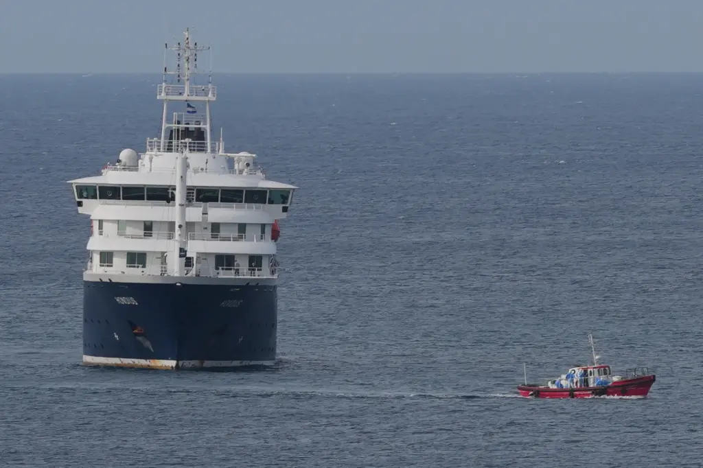 The MV Hondius cruise ship is anchored at a port in Praia, Cape Verde.