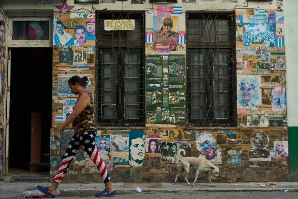 A woman wearing U.S. flag motif pants walks past a...