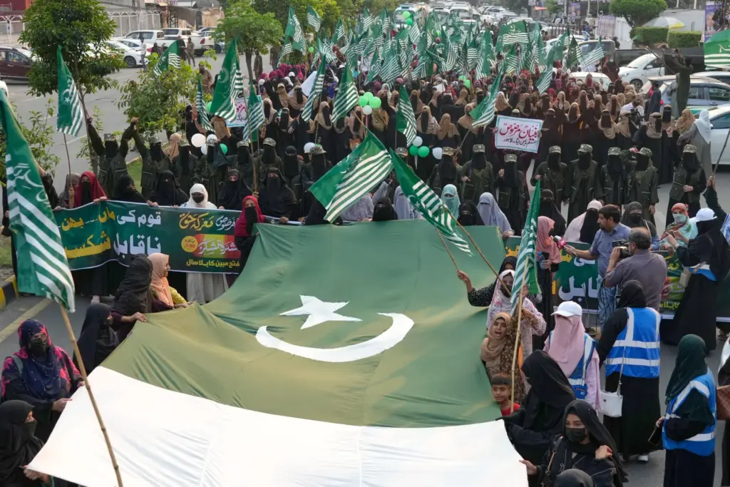 Supporters of the Muslim women league Pakistan, hold a giant Pakistani flag