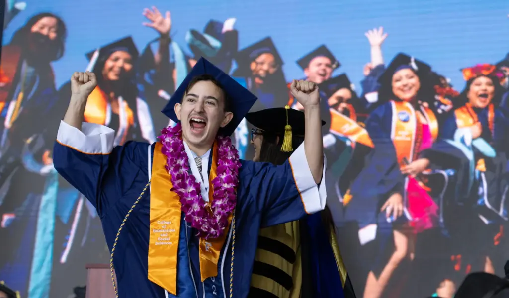 An enthusiastic Andrew Bonilla graduates from Cal State Fullertonâs College...