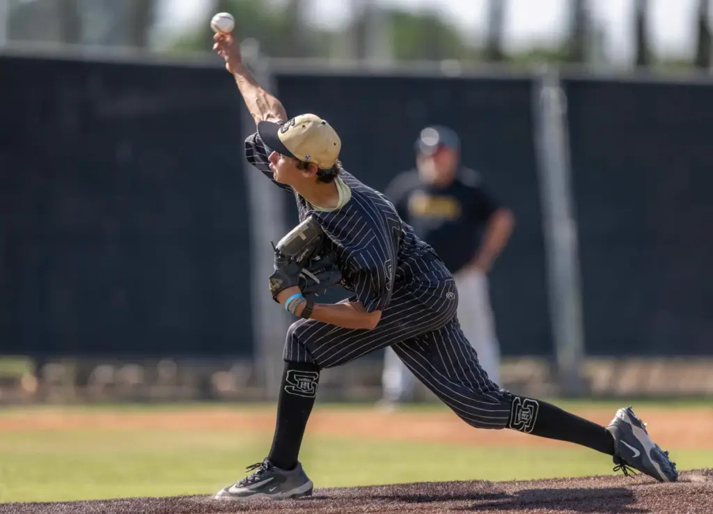 Servite starting pitcher Wyatt Karges throws to home plate during...