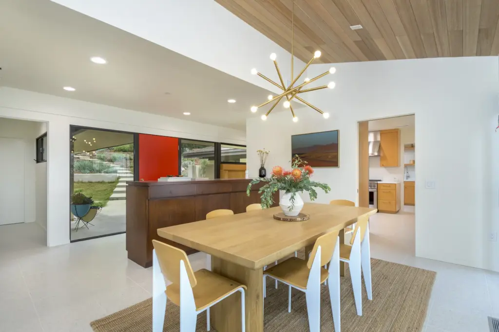 A built-in cabinet separates the entry from the dining room,...