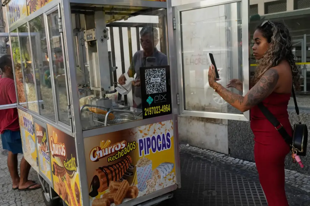 A woman pays for pop corn with the Pix free...