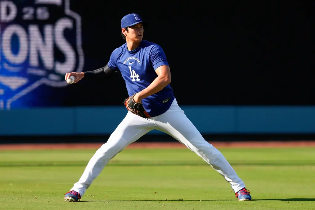 Dodgers two-way star Shohei Ohtani warms up in the outfield...