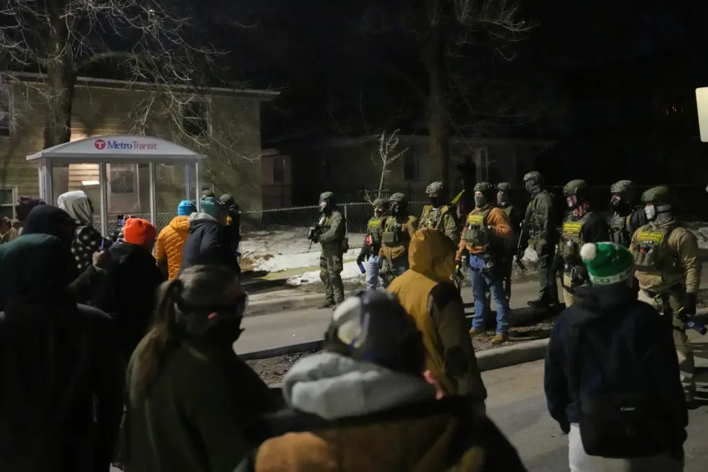 FILE – Protesters confront law enforcement at the scene of...