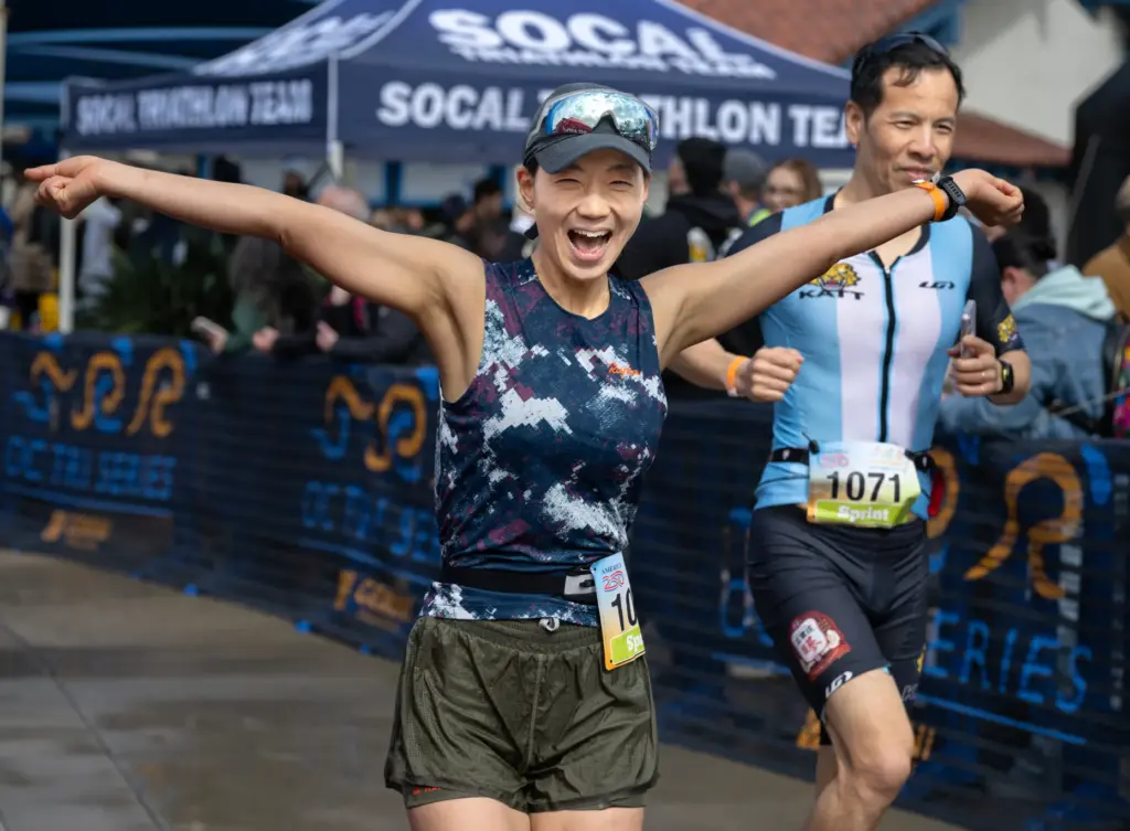 Jihee Kwag celebrates finishing the OC Tri Series triathlon with...