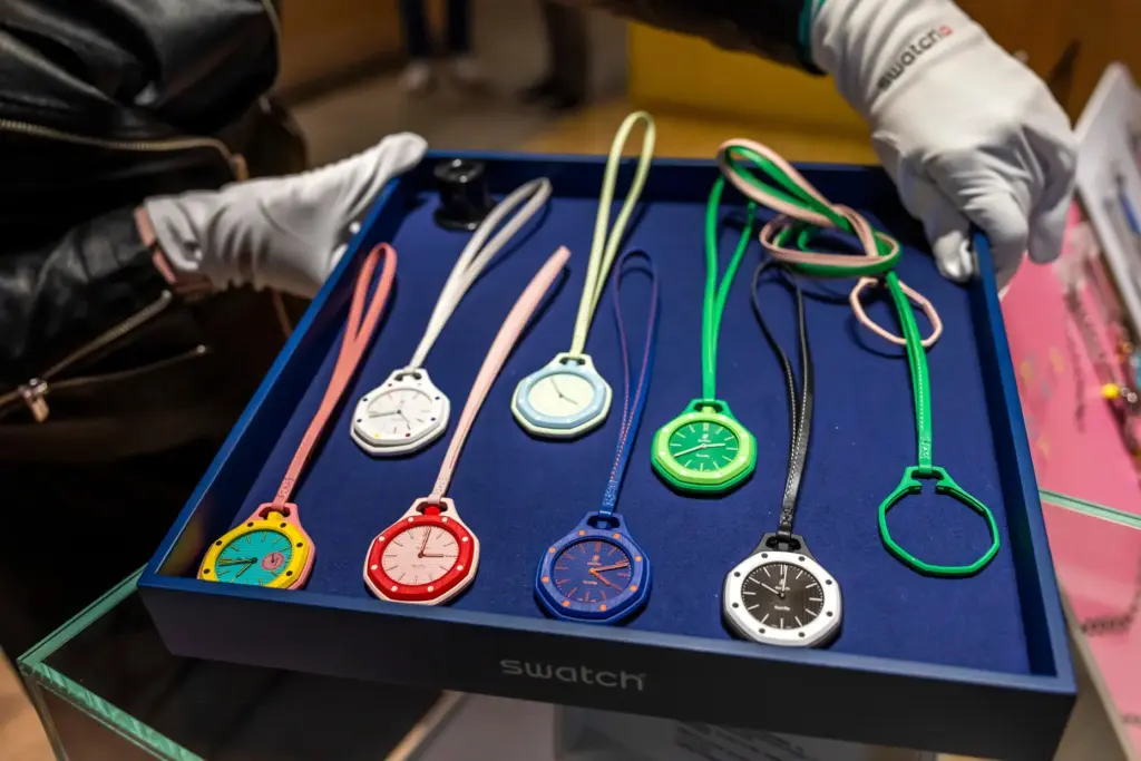 A saleswoman shows the new Royal Pop watches by Swatch...