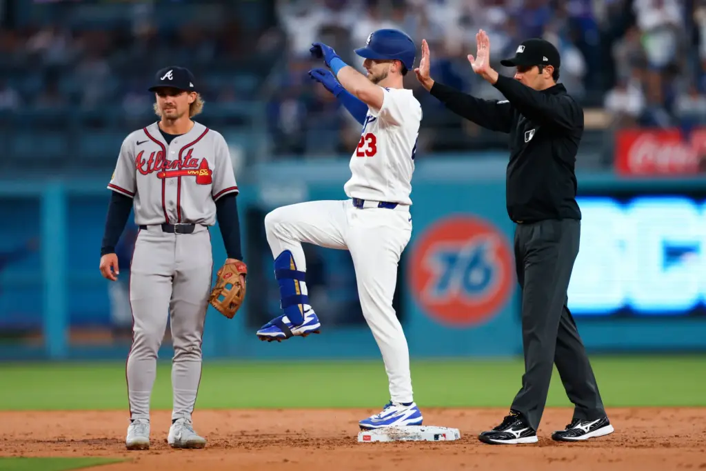 The Dodgers’ Kyle Tucker, center, gestures to his dugout after...