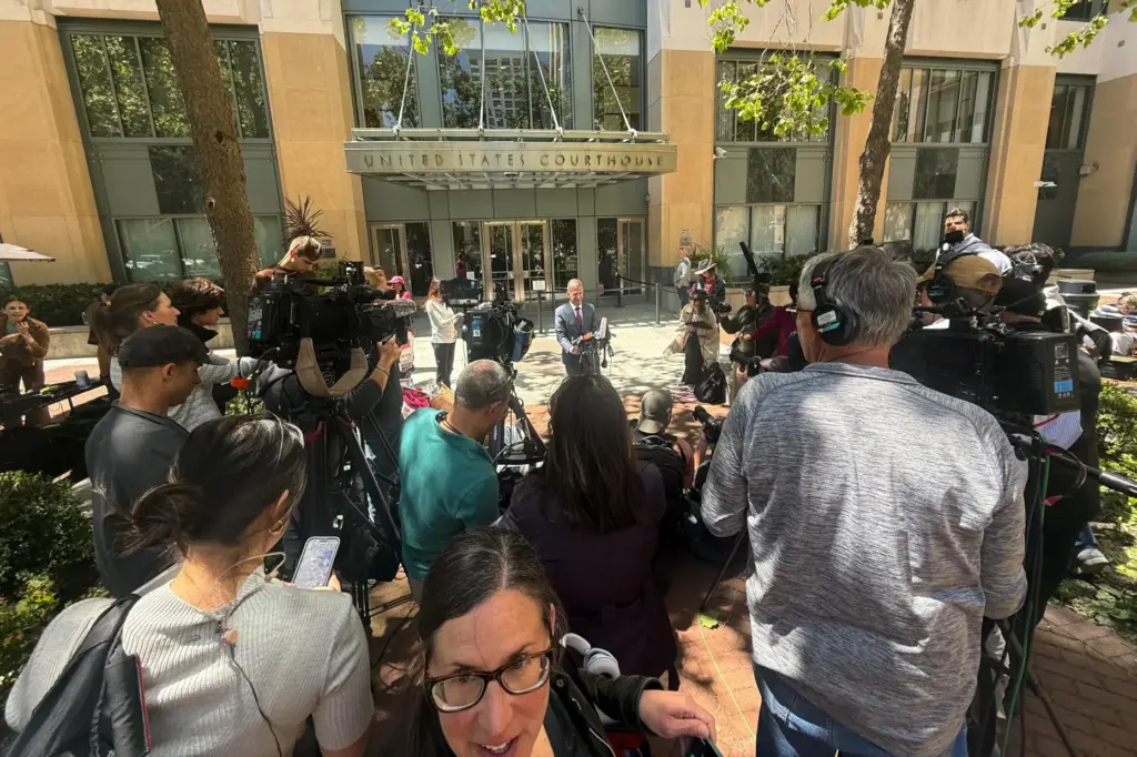 Marc Toberoff, attorney for Elon Musk, is surrounded by media outside court.