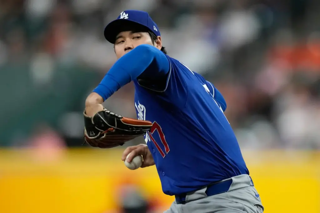 Dodgers starting pitcher Shohei Ohtani throws to the plate during...
