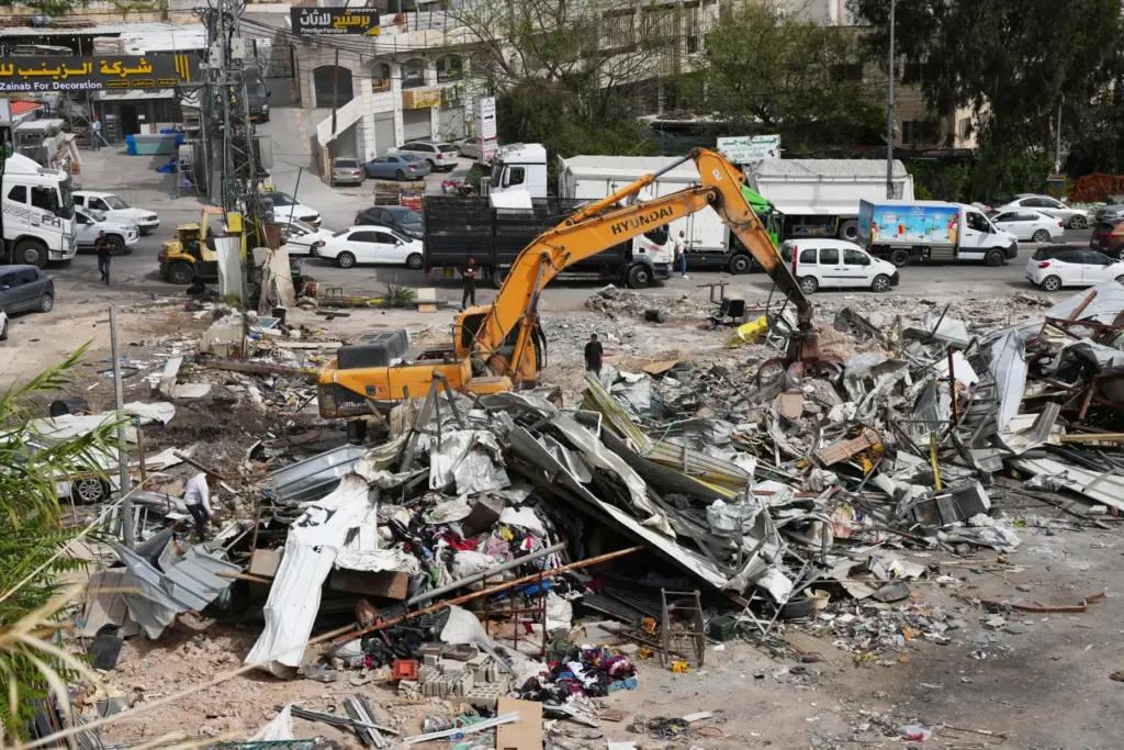 heavy equipment demolishes buildings in the West Bank