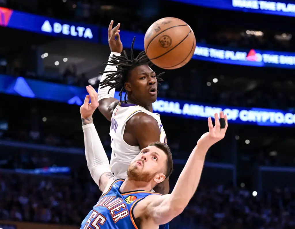 Oklahoma City Thunder center Isaiah Hartenstein, front, and Lakers forward...