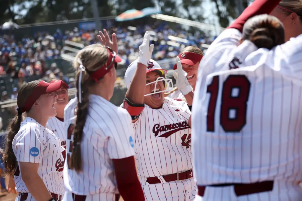 South Carolinaâs Quincee Lilio, center, celebrates after launching a home-run...