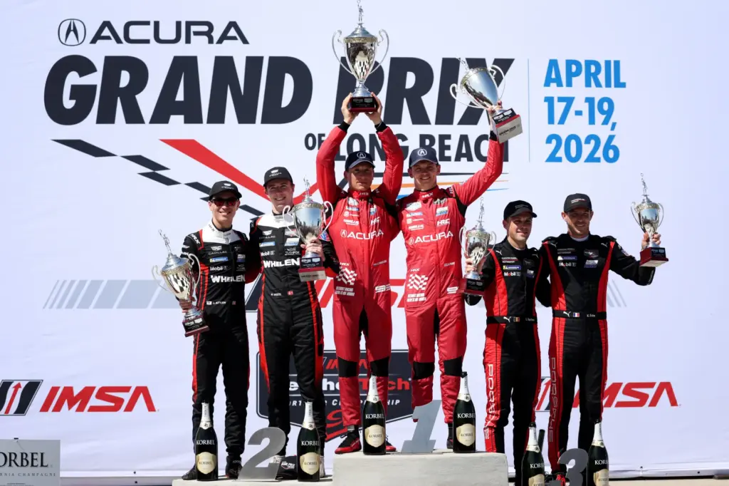 IMSA GTP winners, Renger van der Zande, center left, alongside...