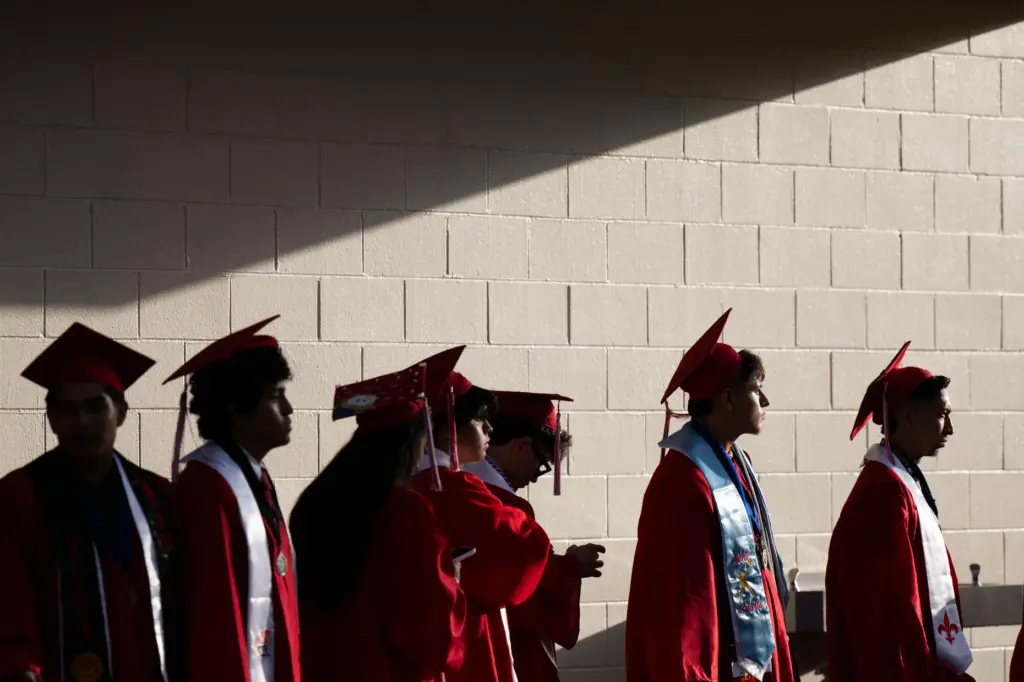 Santa Ana High School graduates line up to walk onto...