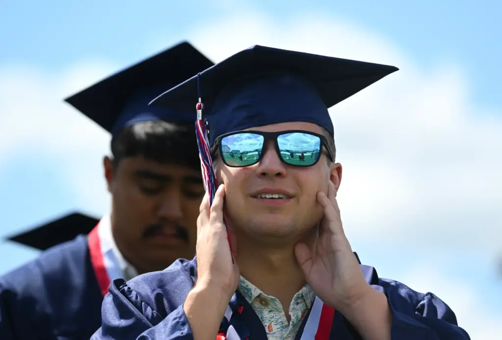 Graduate Dario Gomez enters the commencement ceremony for Beckman High...