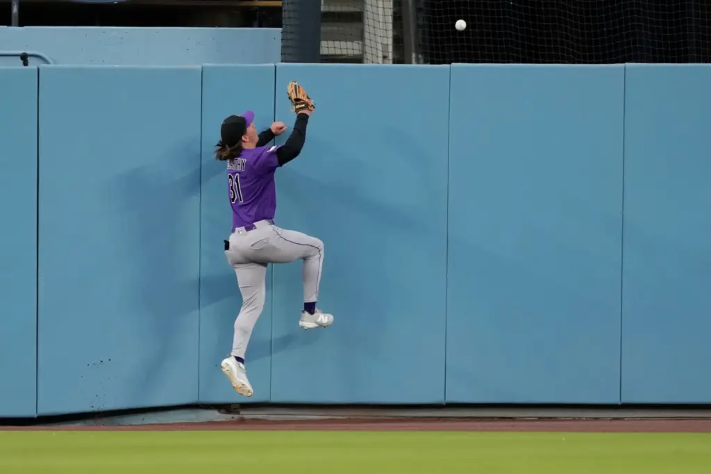 Colorado Rockies center fielder Jake McCarthy can’t get to a...