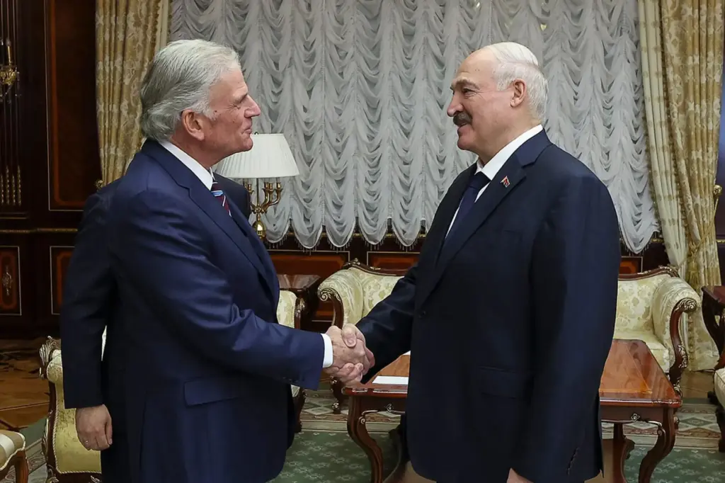 Belarusian President Alexander Lukashenko, right, and U.S. evangelist Franklin Graham shake hands