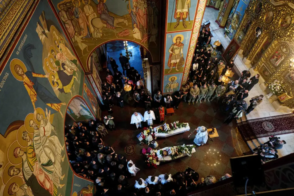 People attend the funeral of sisters Liubava and Vira Yakovlieva.