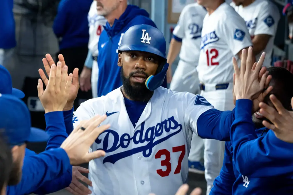 The Dodgers’ Teoscar Hernandez celebrates in the dugout after scoring...