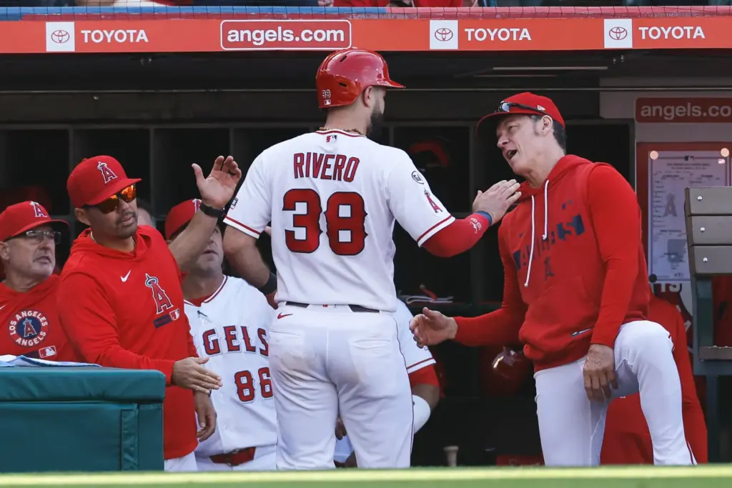 The Angels’ Sebastian Rivero (38) is greeted at the dugout...