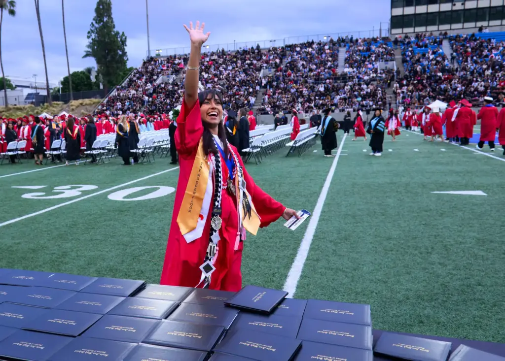 Kuanari Morales Paque waves as she walks onto Eddie West...