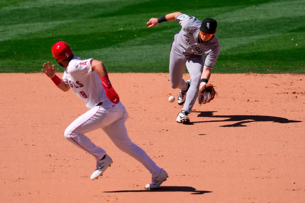 Chicago White Sox shortstop Colson Montgomery, right, fields a ball...