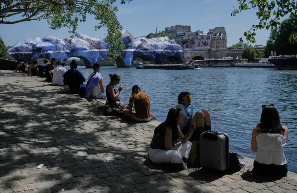 People seek relief from the heat along the Seine River in Paris.