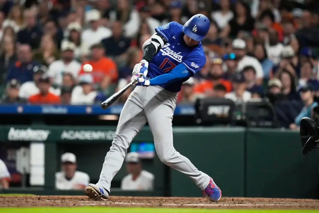 Dodgers designated hitter Shohei Ohtani hits a fly ball for...