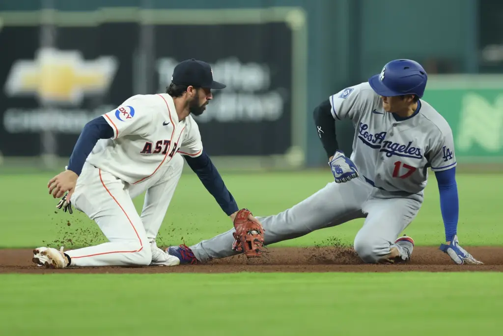 Dodgers star Shohei Ohtani, right, steals second base as Houston...