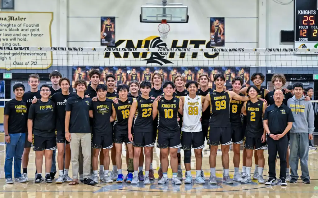 Foothill players and coaches stand together at the net as...