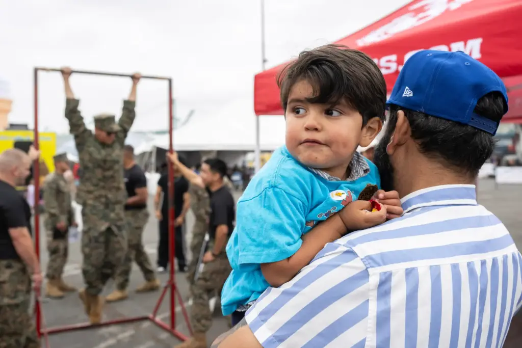 From right, Jose Alonzo and two-year-old Benjamin Alonzo attend day...