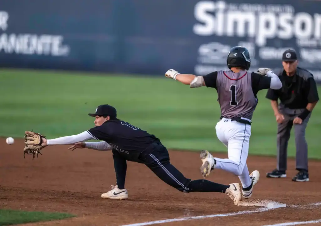 Glendora shortstop John Seader gets safely to first base, just...