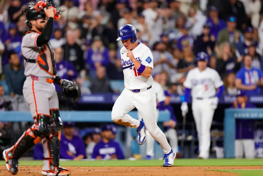 The Dodgers’ Alex Call, right, runs past San Francisco Giants...