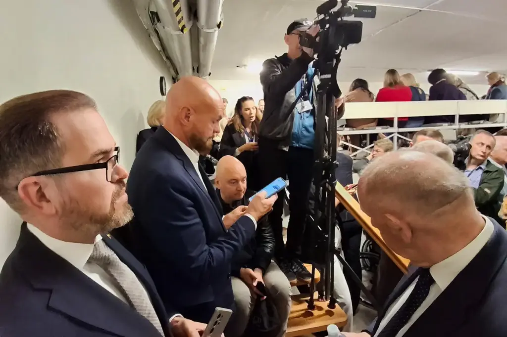 Members of parliament and media representatives gather in a shelter at the parliament building in Vilnius
