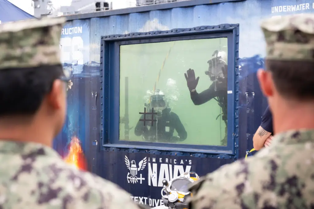 Members of the Seabee Divers wave to attendees of the...