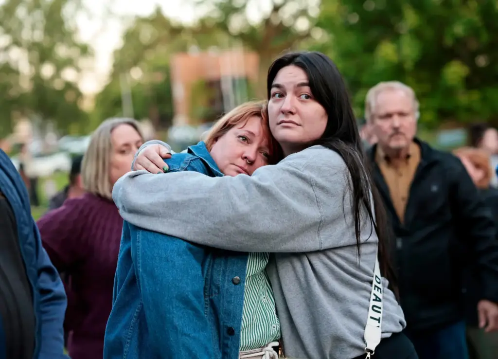 Diana Winther, left, and Kellie Webber, embrace in a hug