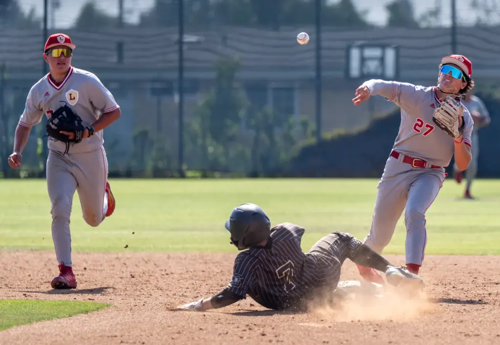 Orange Lutheran second baseman C.J. Weinstein tags out Serviteâs Lucas...