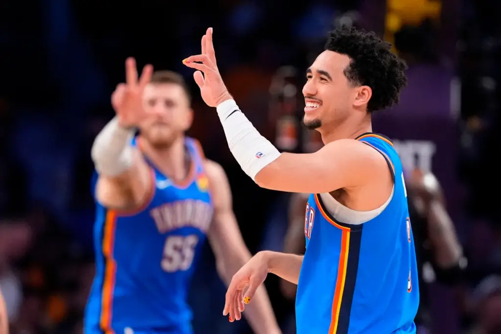 Oklahoma City Thunder guard Jared McCain, right, gestures along with...