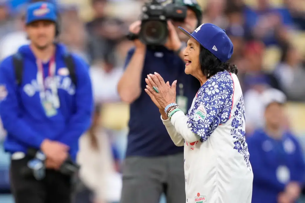 Labor leader Dolores Huerta claps after throwing out the ceremonial...