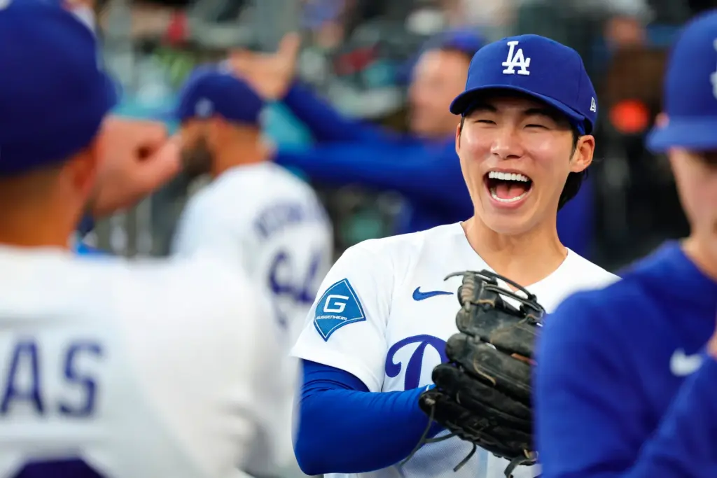 Dodgers second baseman Hyeseong Kim reacts in the dugout before...