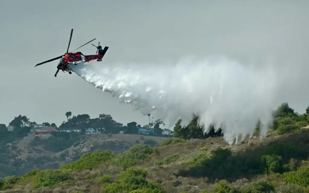 An OCFA Firehawk demonstrates a water drop after sucking up...