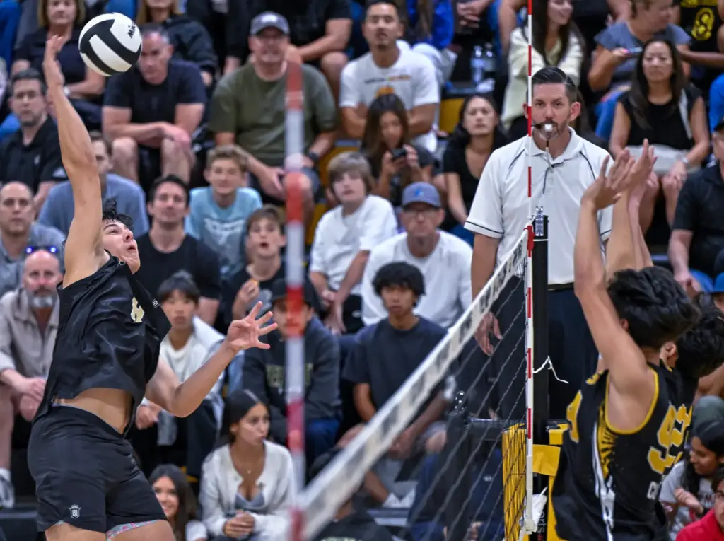 Servite outside hitter John Burdge hits the ball during the...