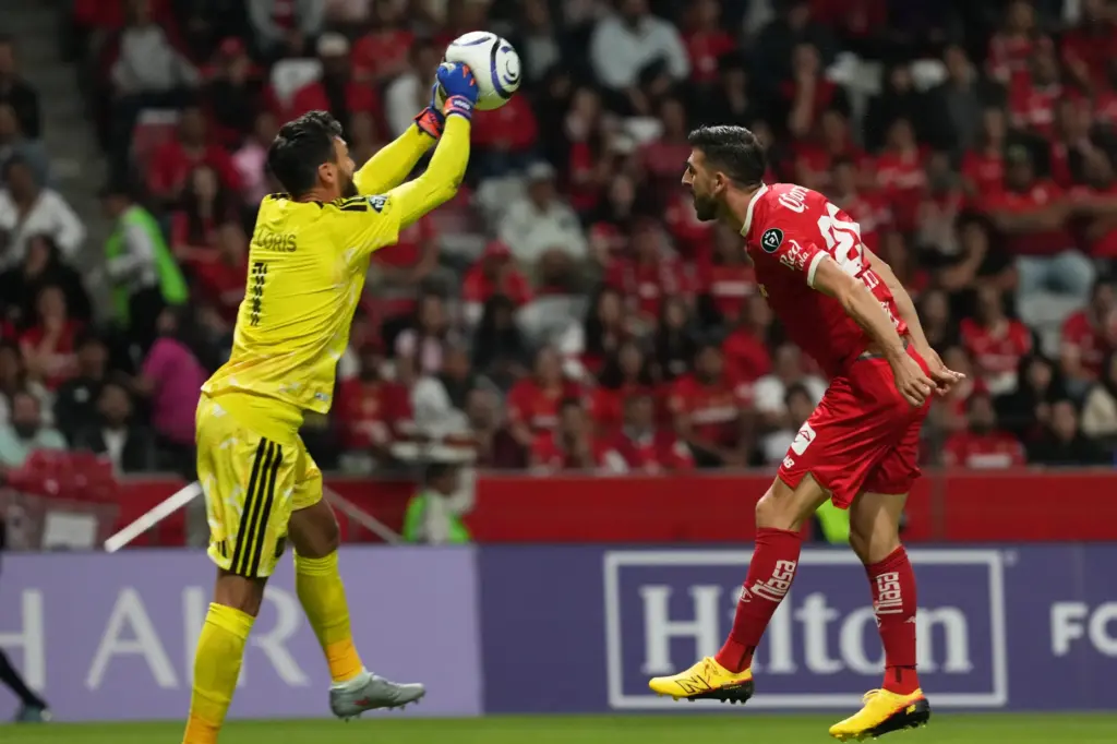 LAFC goalkeeper Hugo Lloris, left, clears the ball in front...