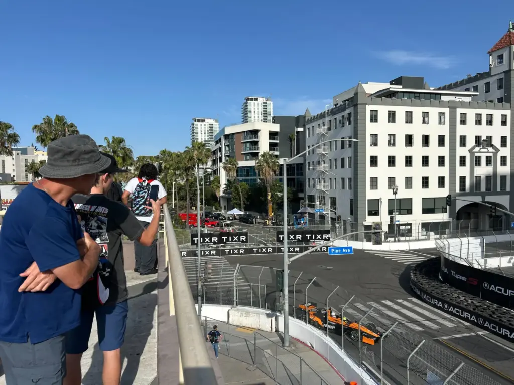 Early bird fans watch race cars zip around the 1.97-mile...