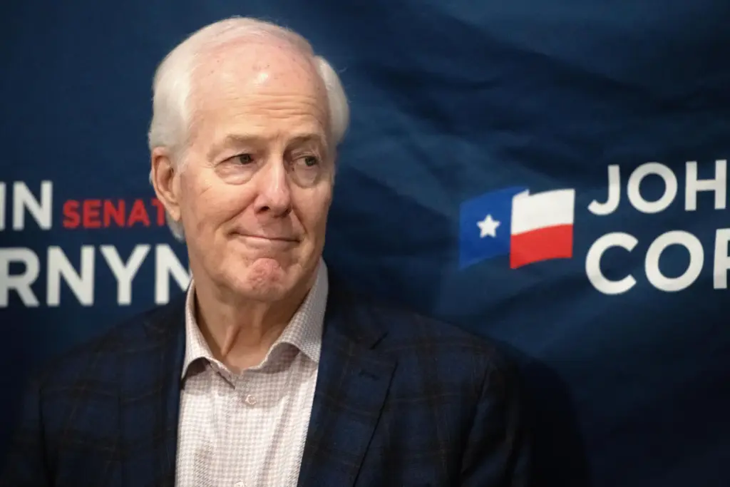 Sen. John Cornyn, R-Texas, listens to State Sen. Charles Perry, R-Lubbock.