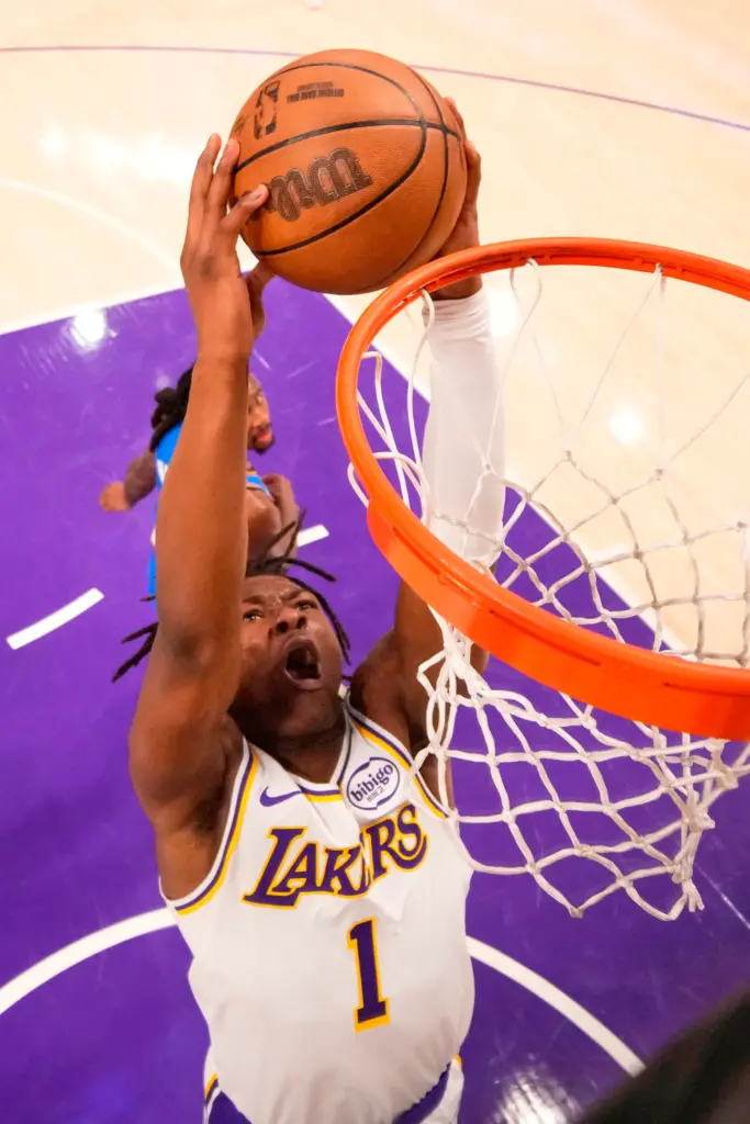 Lakers forward Adou Thiero, below, dunks as Oklahoma City Thunder...