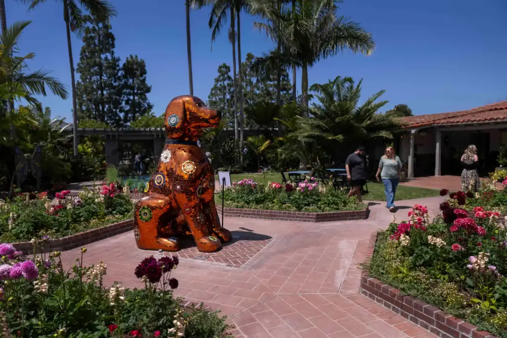 The mosaic dog sculpture Honey is the centerpiece of the...